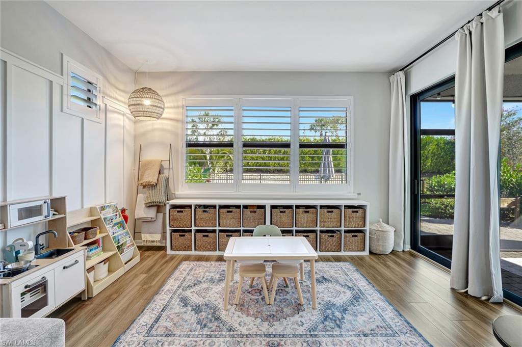 2240 Yellowfin Circle Naples, FL 34114 - Photo 10 of 38 Living room extension featuring plenty of natural light, impact windows and luxury vinyl flooring