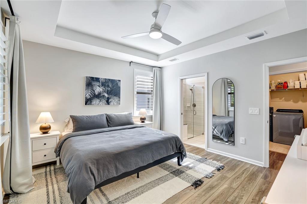 2240 Yellowfin Circle Naples, FL 34114 - Photo 12 of 38 Master Bedroom with a tray ceiling, ceiling fan and ensuite bathroom