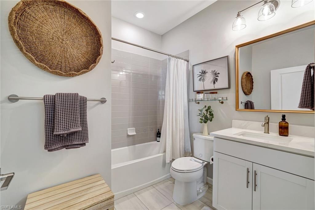 2240 Yellowfin Circle Naples, FL 34114 - Photo 16 of 38 Full bath featuring shower / bath combination with curtain, vanity, and recessed lighting