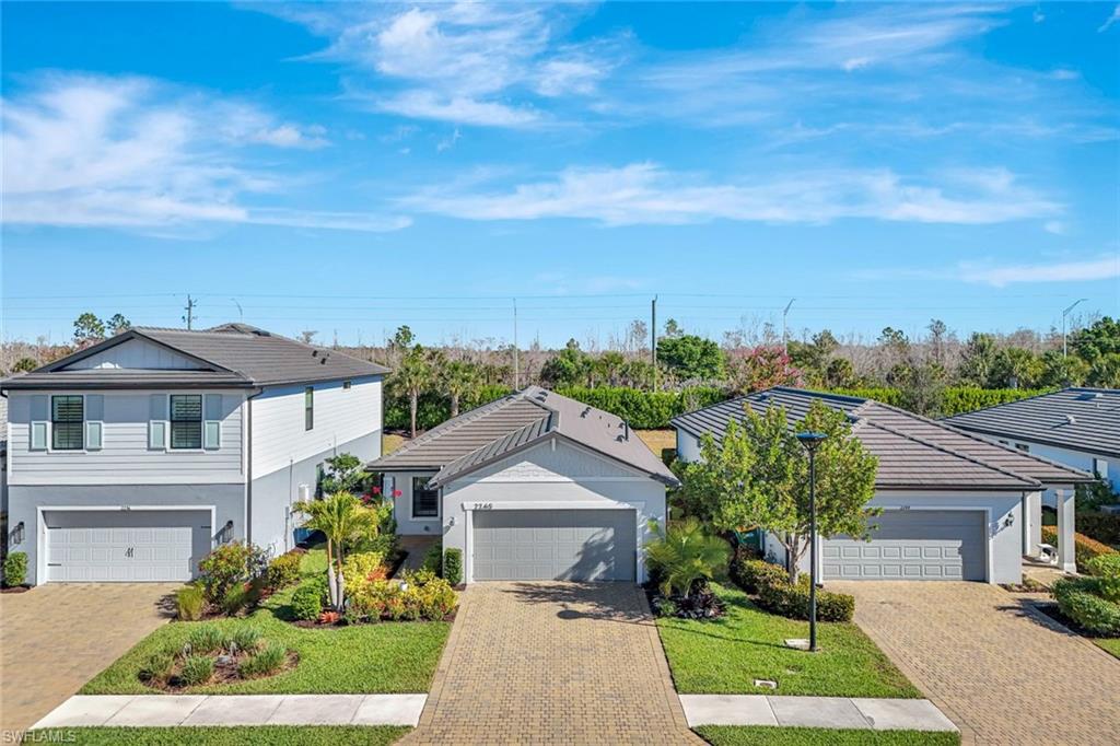2240 Yellowfin Circle Naples, FL 34114 - Photo 23 of 38 View of front of property with a garage and brick paver driveway
