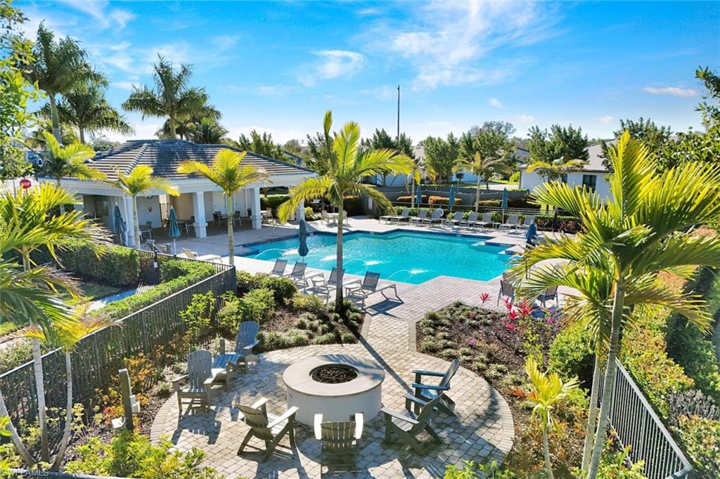 2240 Yellowfin Circle Naples, FL 34114 - Photo 26 of 38 Community pool featuring a patio and an outdoor fire pit