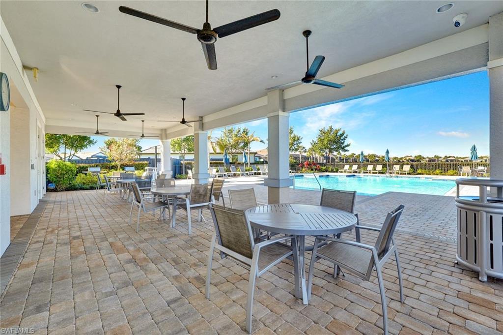 2240 Yellowfin Circle Naples, FL 34114 - Photo 29 of 38 View of patio featuring outdoor dining space, grilling space, a community pool and ceiling fans