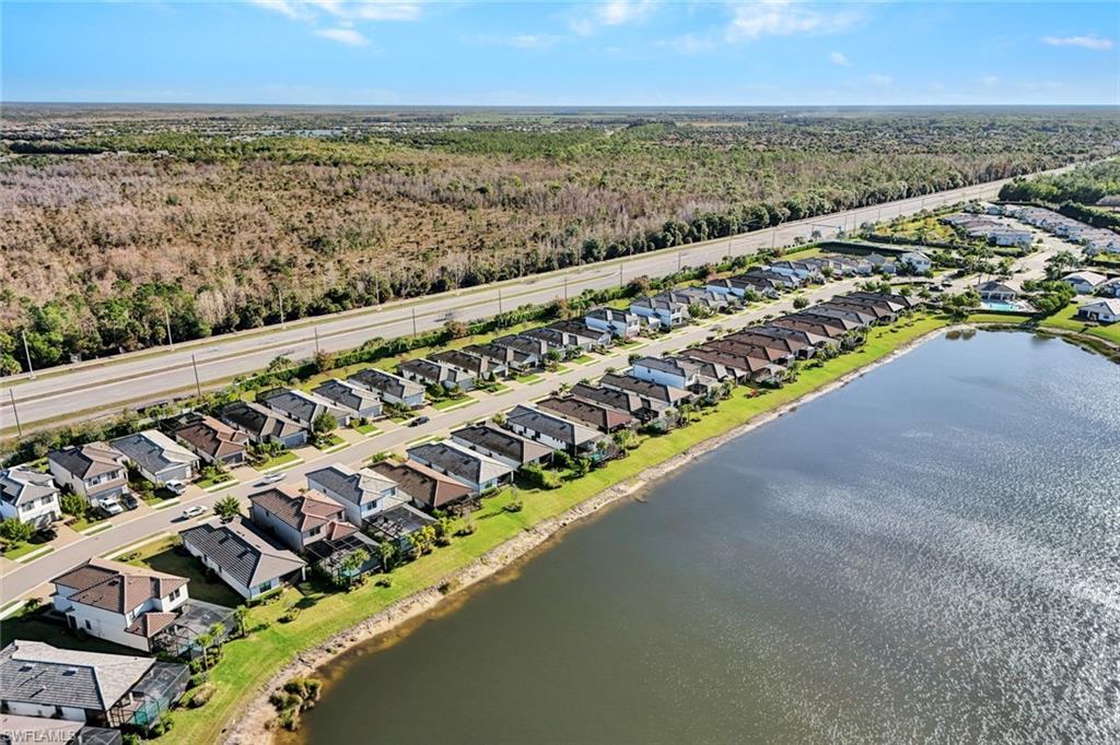 2240 Yellowfin Circle Naples, FL 34114 - Photo 36 of 38 Aerial perspective of community featuring a lake
