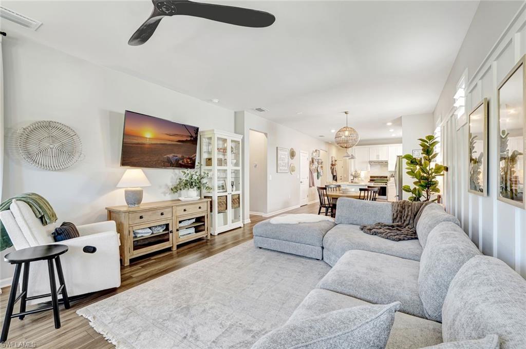 2240 Yellowfin Circle Naples, FL 34114 - Photo 8 of 38 Extended living area featuring natural light, luxury vinyl flooring and ceiling fan