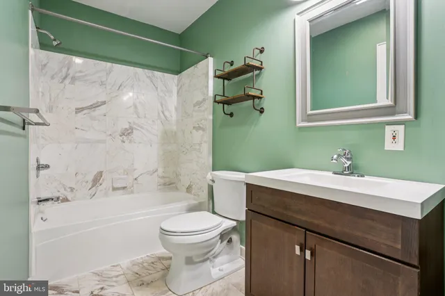 a view of a hallway with wooden floor and closet