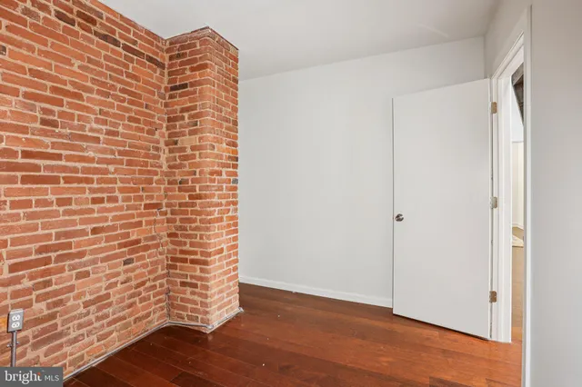 a view of an empty room and wooden floor