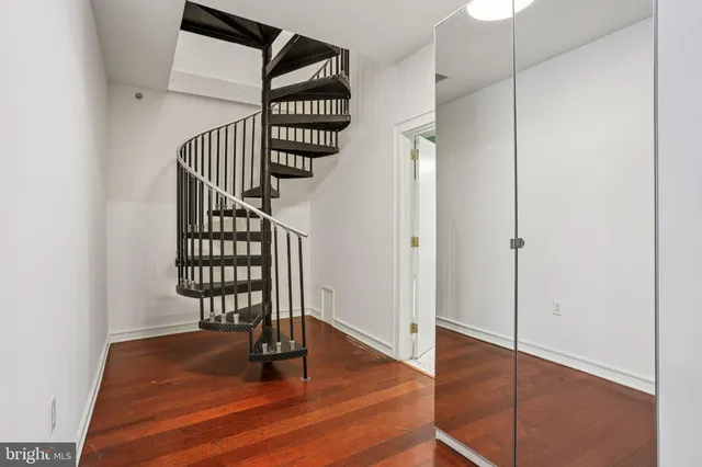 a view of a room with wooden floor