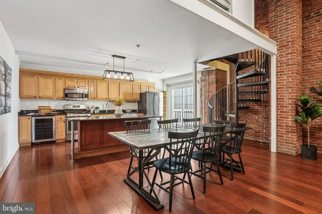 a kitchen with stainless steel appliances granite countertop a sink a stove and cabinets