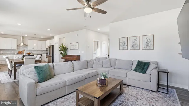 a living room with furniture and kitchen view