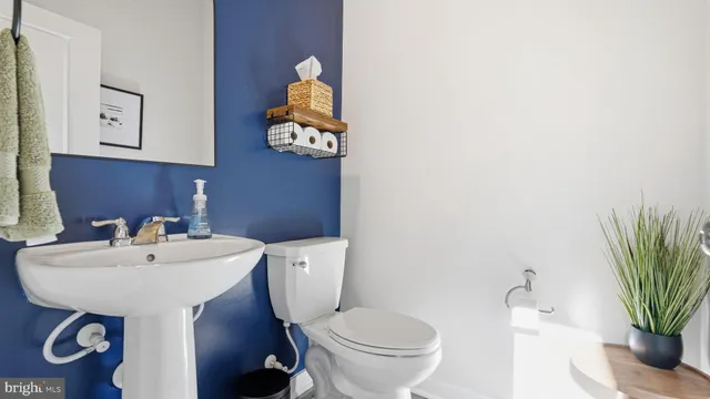 a bathroom with a sink mirror and toilet