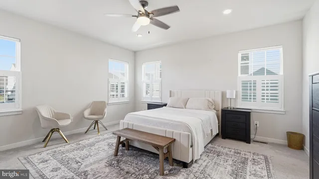 a bedroom with a bed a table and chair