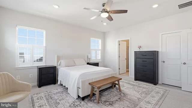 a bedroom with a bed closet and a window