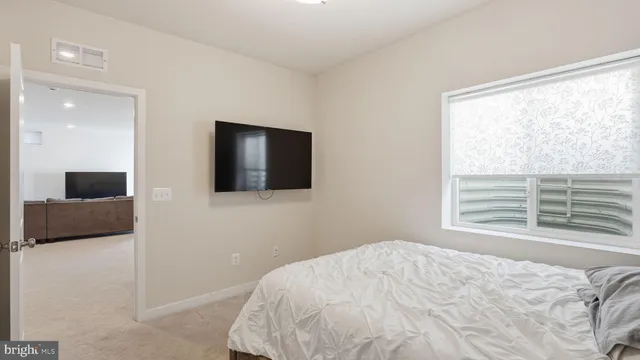 a bedroom with a bed and a television