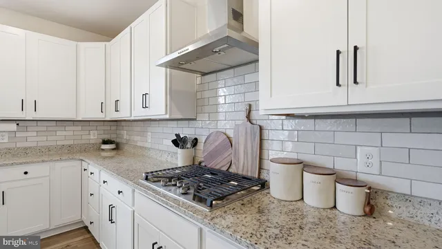 a kitchen with a stove and cabinets