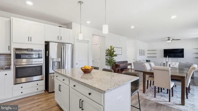a kitchen with a table chairs refrigerator and microwave