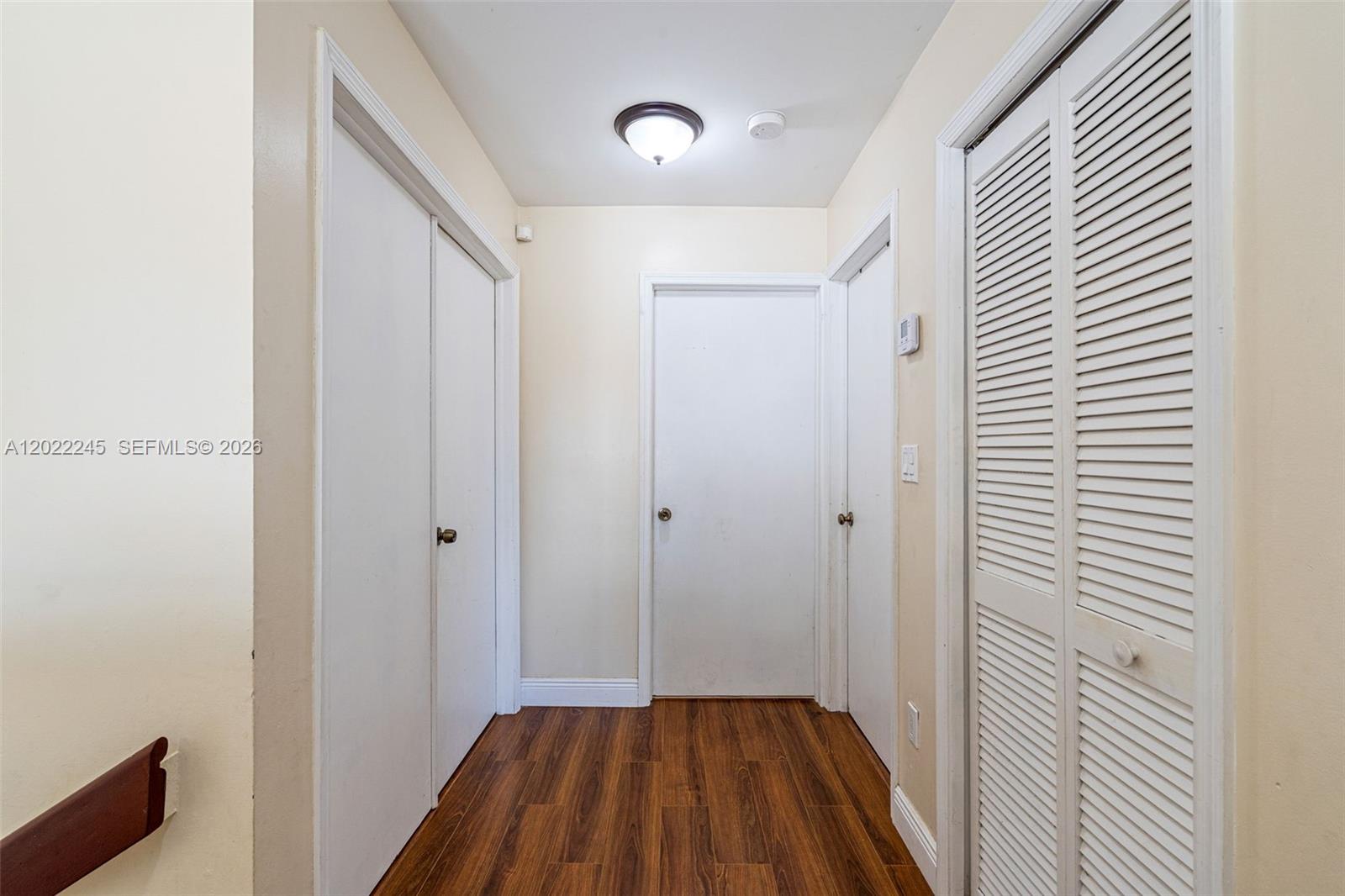 15530 Southwest 59th Street Miami, FL 33193 - Photo 21 of 58 a view of a room with wooden floor cabinet and a bathroom