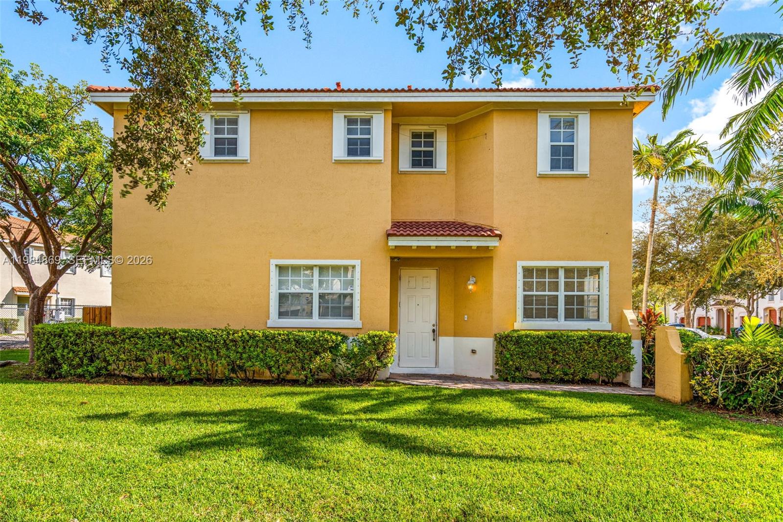 a front view of a house with a garden