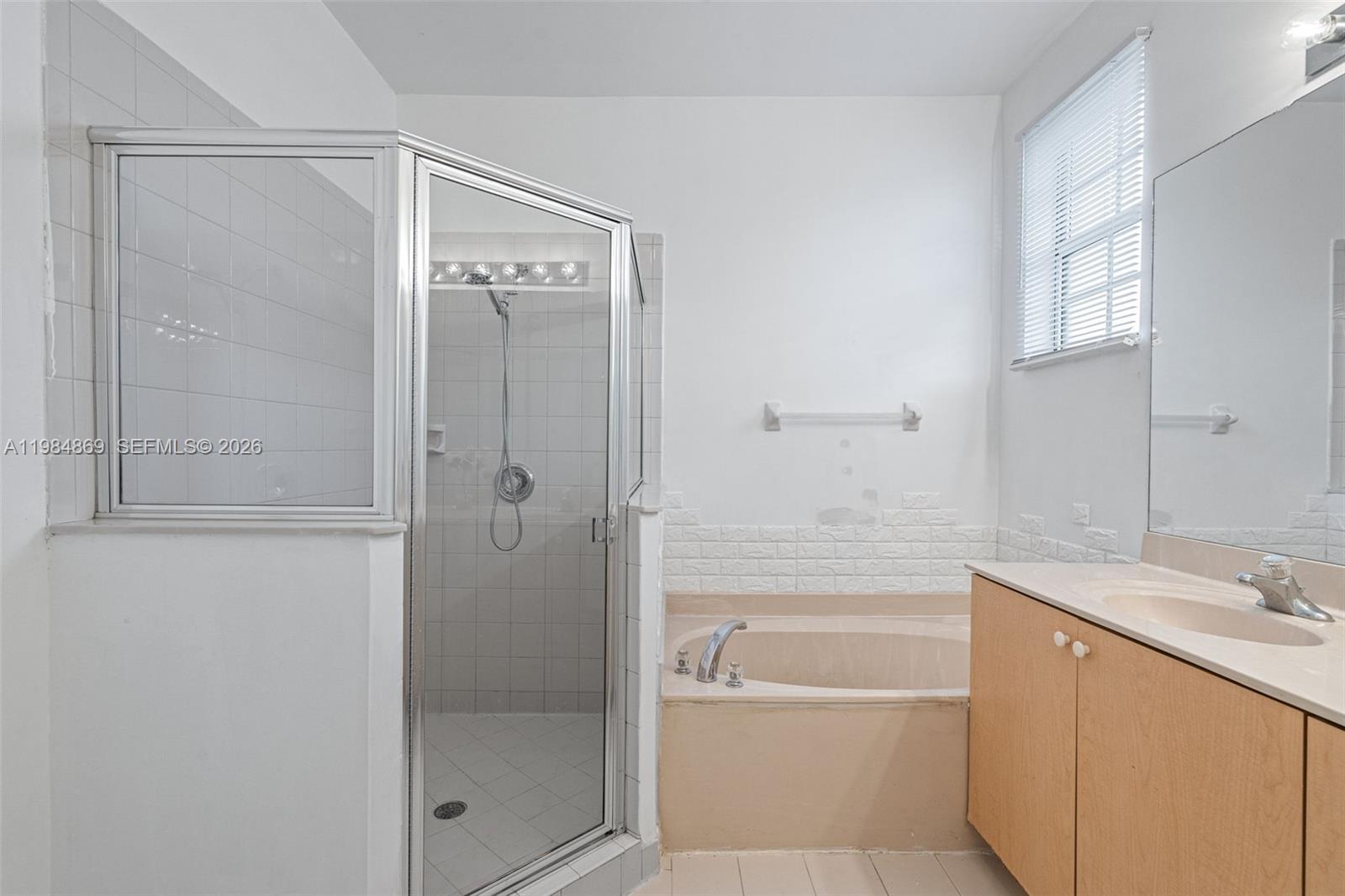 2109 Northeast 3rd Court Homestead, FL 33033 - Photo 11 of 19 a bathroom with a bathtub shower sink vanity and mirror