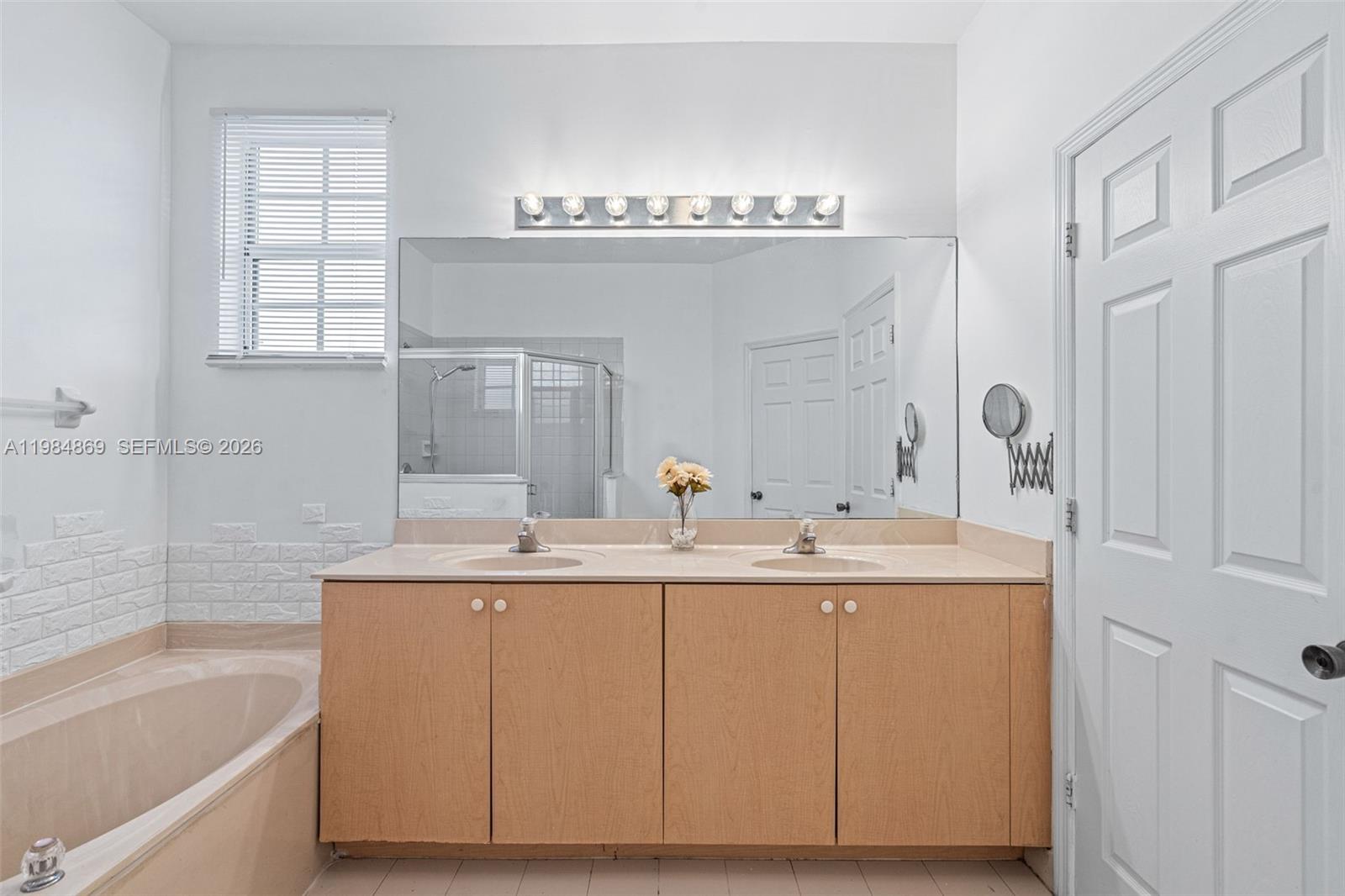 2109 Northeast 3rd Court Homestead, FL 33033 - Photo 12 of 19 a bathroom with a sink double vanity and a bathtub