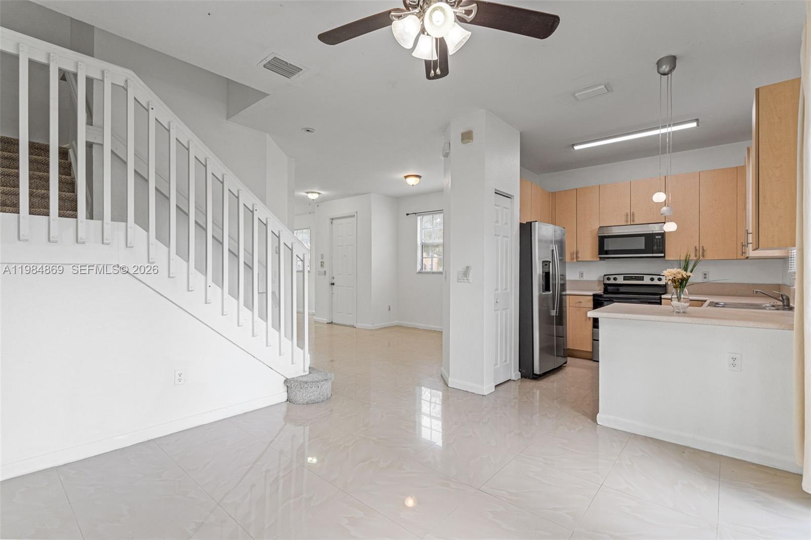 2109 Northeast 3rd Court Homestead, FL 33033 - Photo 6 of 19 a view of a kitchen with a refrigerator a microwave and a refrigerator
