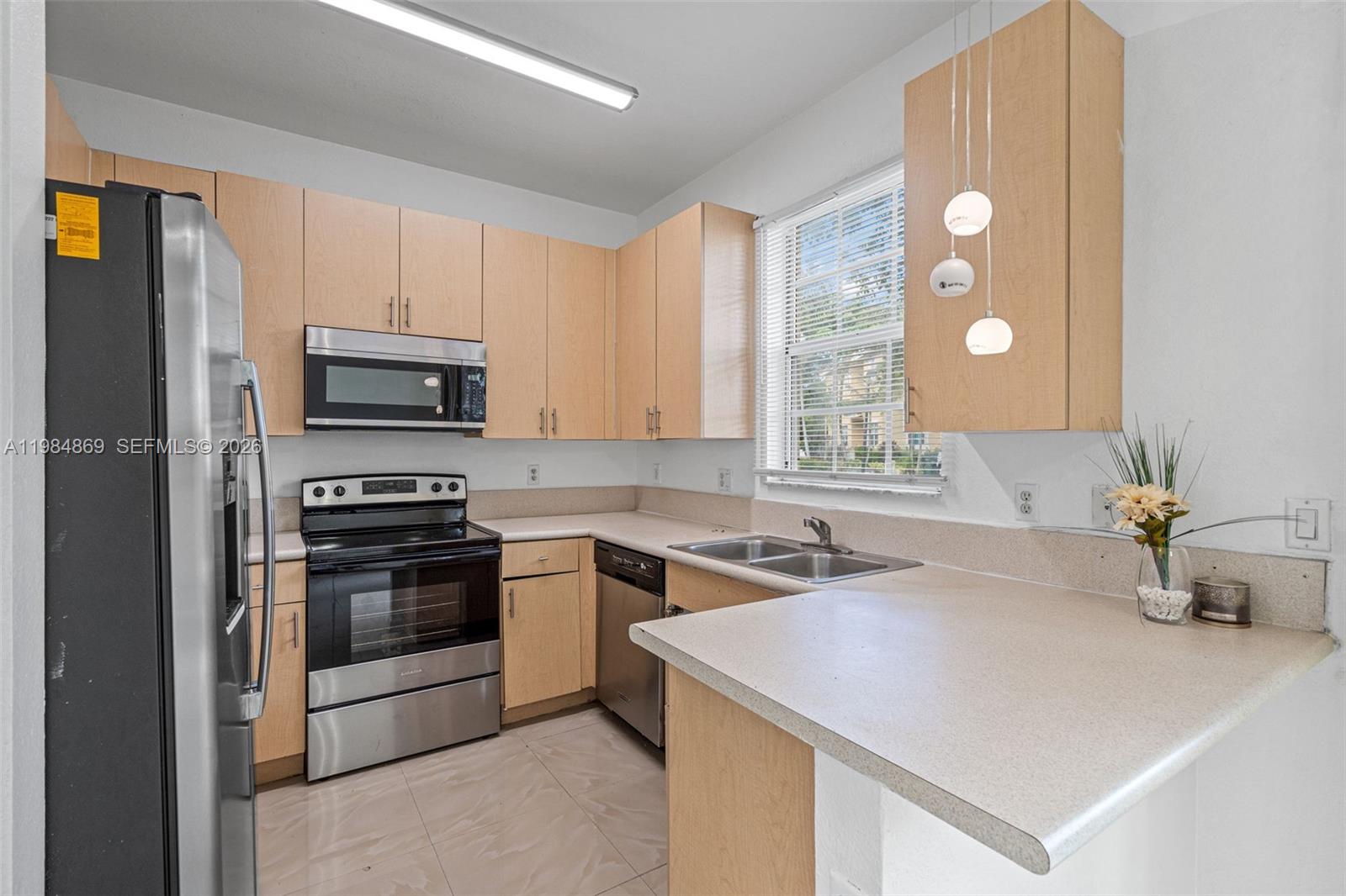 2109 Northeast 3rd Court Homestead, FL 33033 - Photo 9 of 19 a kitchen with a sink appliances and cabinets
