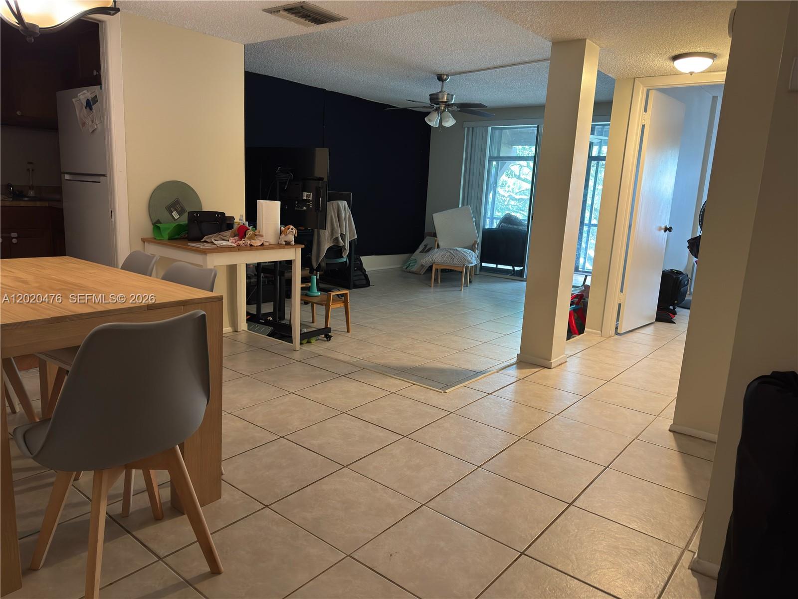 3750 Inverrary Drive, Unit 3Q Lauderhill, FL 33319 - Photo 2 of 2 a dining room with furniture and a rug