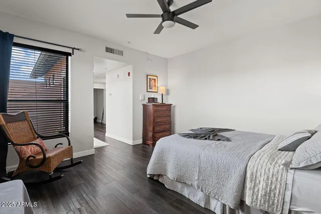 a bedroom with a bed and wooden floor