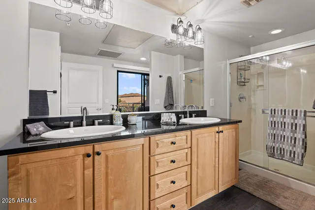 a bathroom with double sink and a mirror