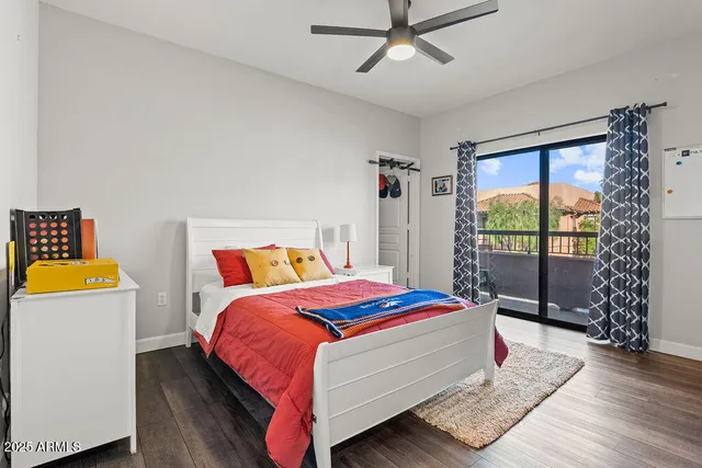 a bed sitting in a bedroom next to a window