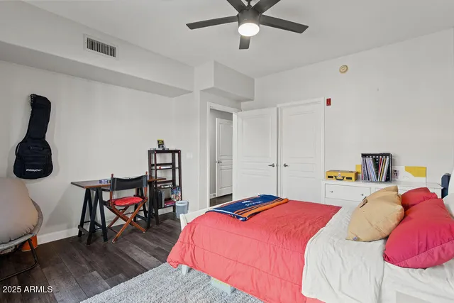 a bedroom with a bed and cabinets