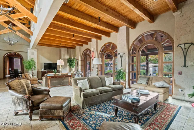 a living room with fireplace furniture and a rug