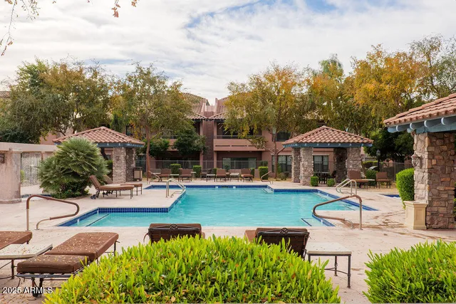 an aerial view of a house with swimming pool garden and patio