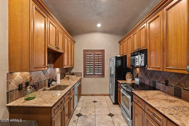 a kitchen with a sink stove and cabinets