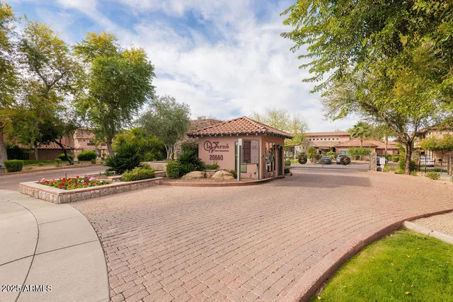 a street view with tall buildings and cars parked on road