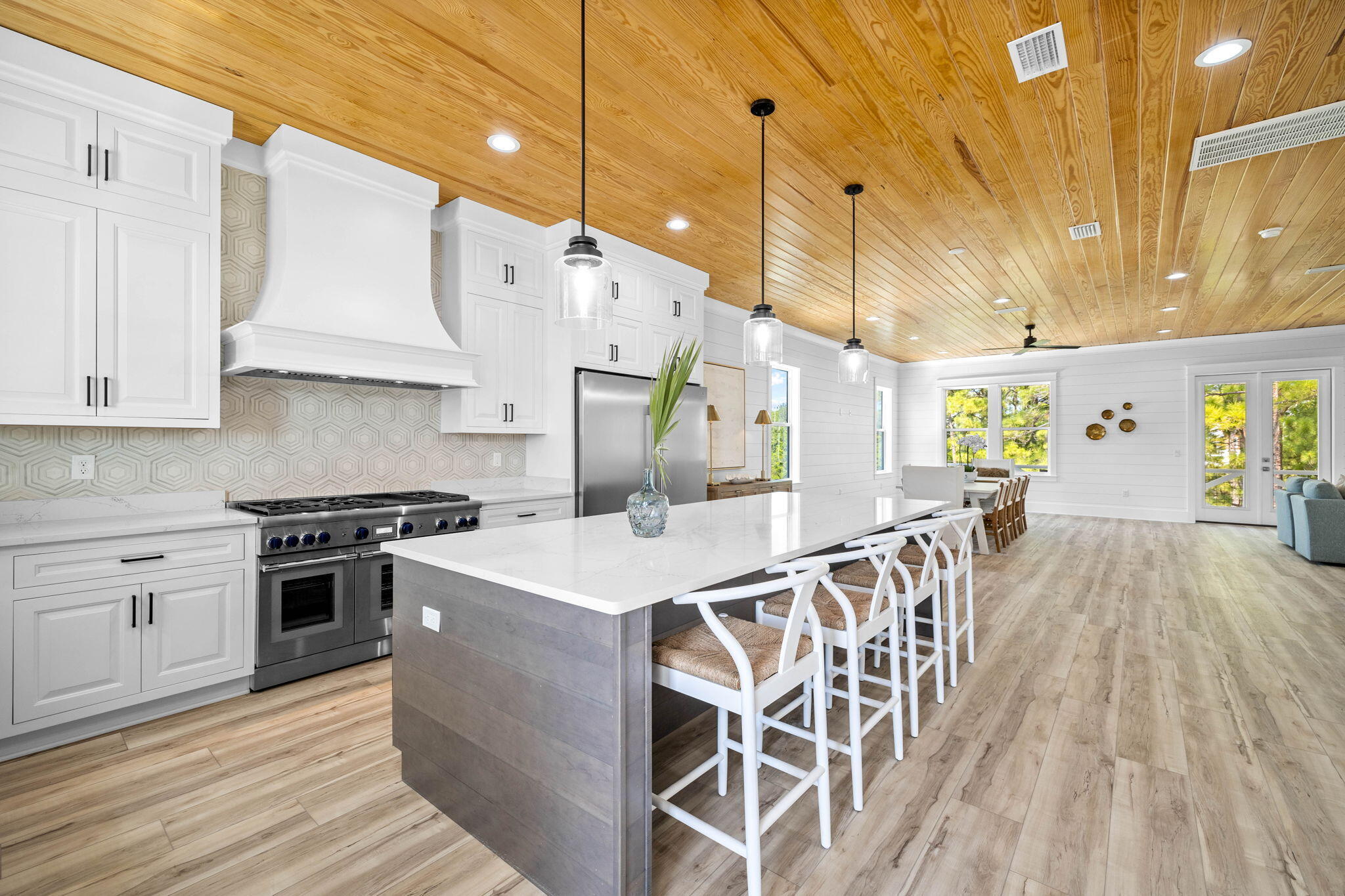 169 Baird Road Santa Rosa Beach, FL 32459 - Photo 16 of 93 a open kitchen with stainless steel appliances granite countertop a stove a sink dishwasher and a refrigerator with wooden floor