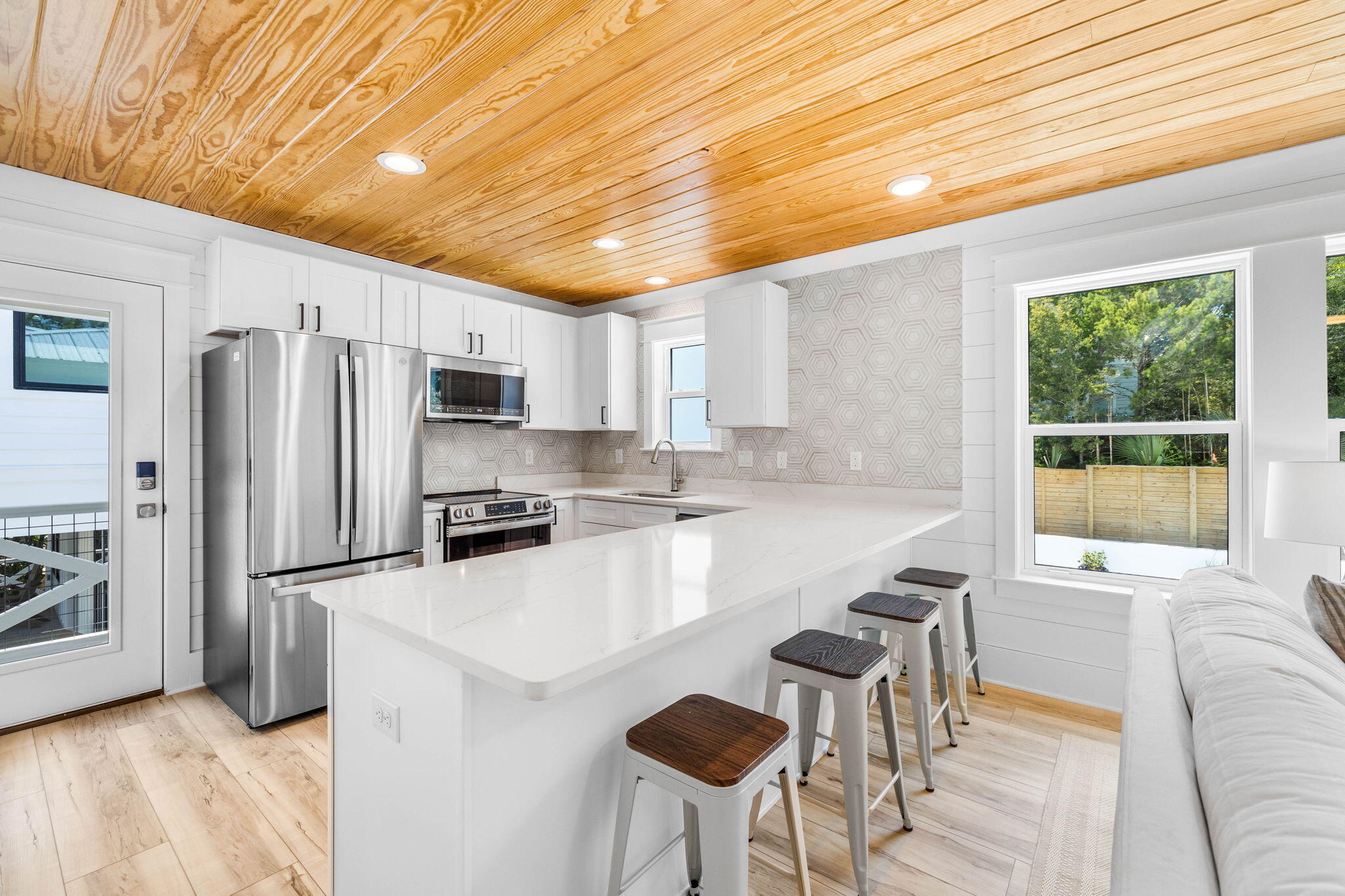 169 Baird Road Santa Rosa Beach, FL 32459 - Photo 79 of 93 a kitchen with stainless steel appliances granite countertop a sink a stove a refrigerator cabinets and a dining table