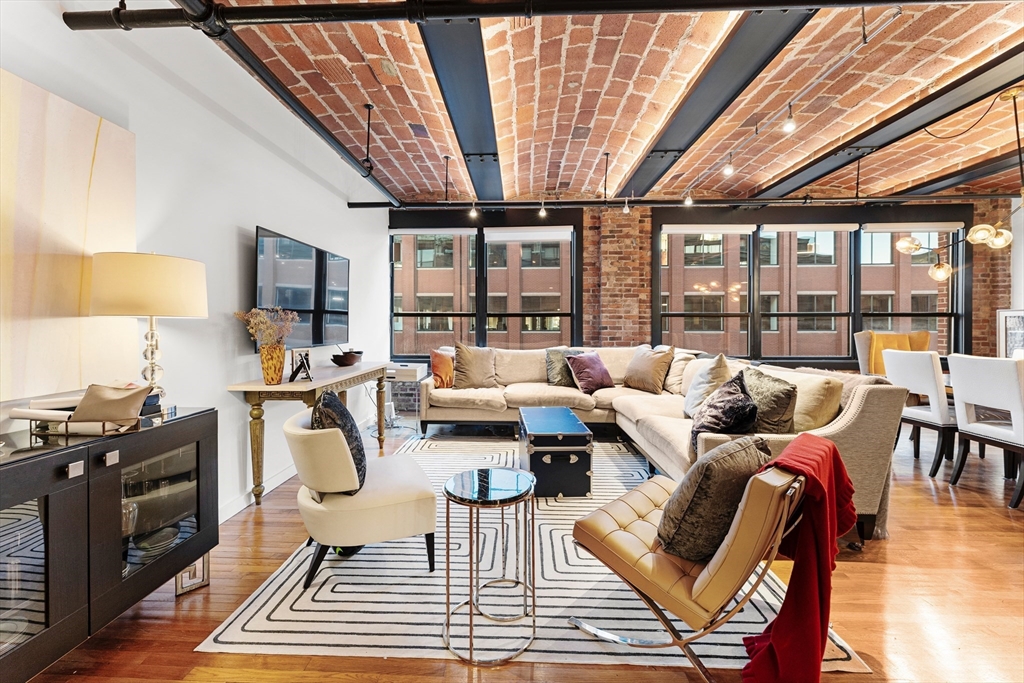 a living room with furniture and a floor to ceiling window