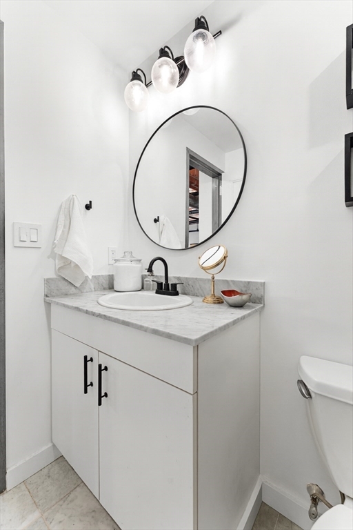 121 Beach Boston Ma, Unit 502 Boston, MA 02111 - Photo 12 of 21 a bathroom with a sink mirror and toilet