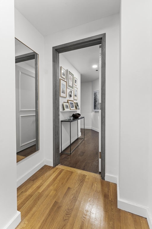 121 Beach Boston Ma, Unit 502 Boston, MA 02111 - Photo 13 of 21 a view of a livingroom with wooden floor and a bathroom