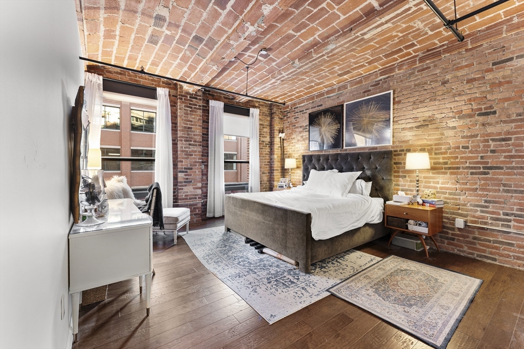 121 Beach Boston Ma, Unit 502 Boston, MA 02111 - Photo 15 of 21 a bed sitting in a spacious bedroom next to a window