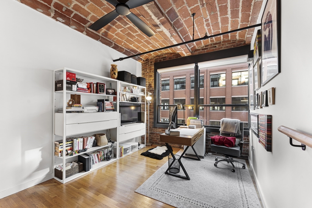 121 Beach Boston Ma, Unit 502 Boston, MA 02111 - Photo 9 of 21 a living room with furniture and a book shelf