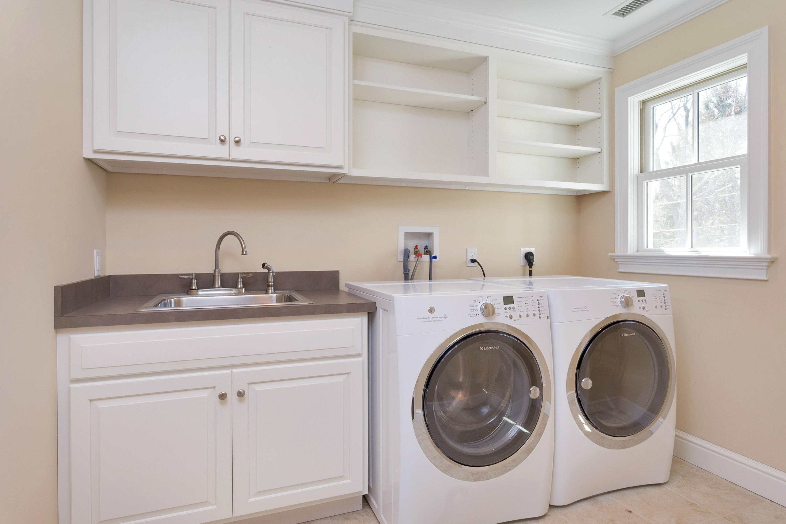 31 Edgewood Road Darien, CT 06820 - Photo 15 of 25 a utility room with sink dryer and washer