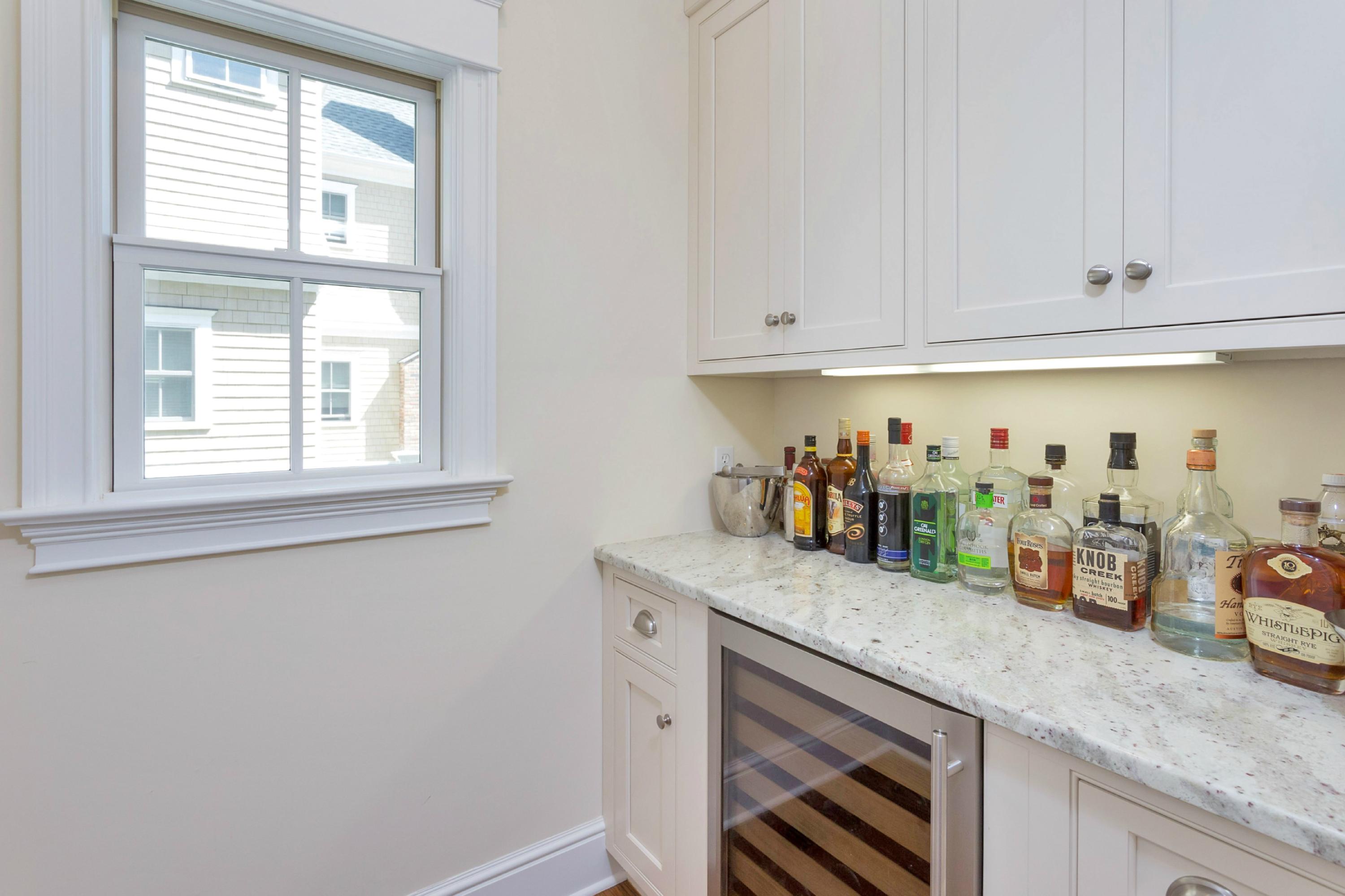 31 Edgewood Road Darien, CT 06820 - Photo 5 of 25 a kitchen with granite countertop white cabinets and white appliances