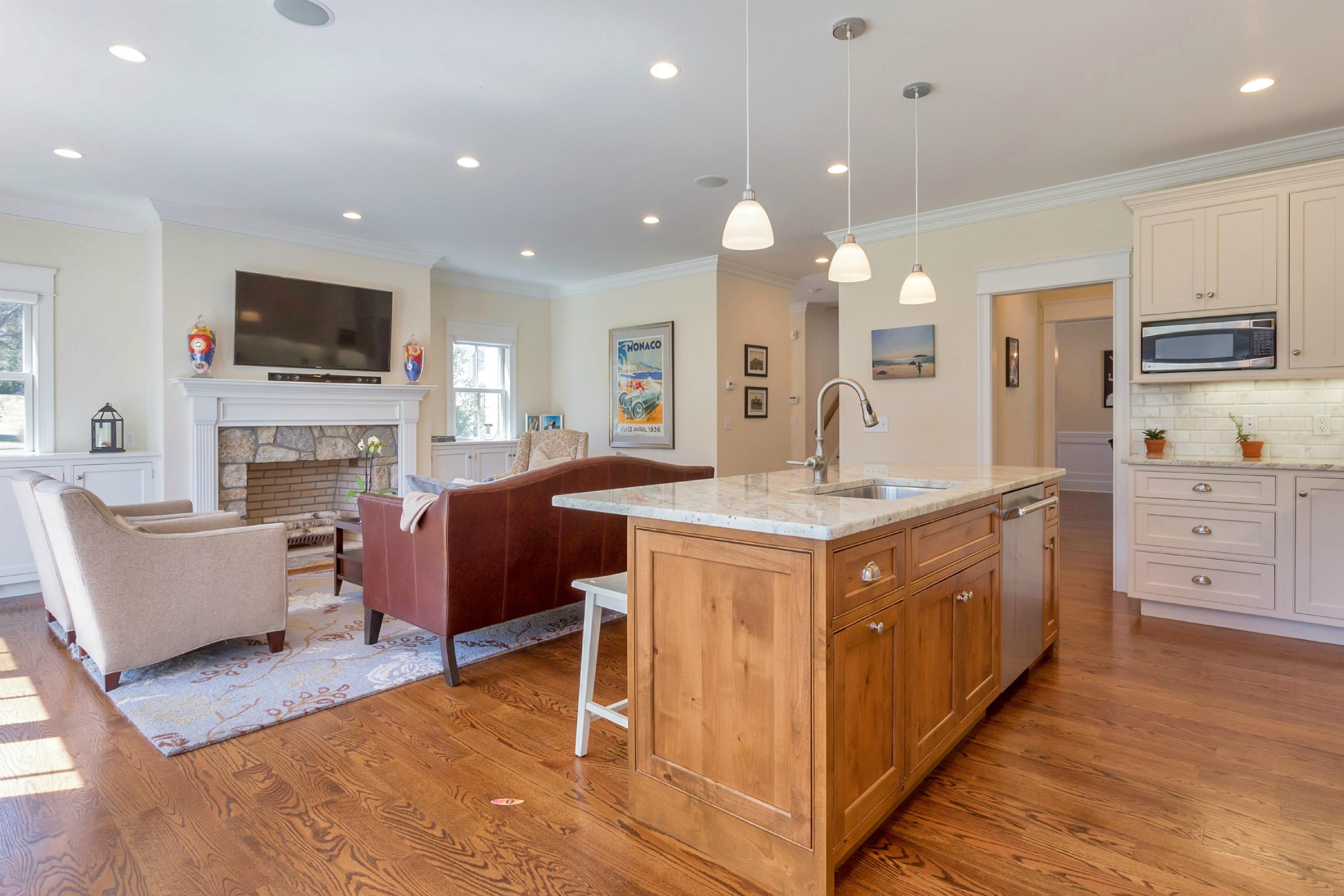 31 Edgewood Road Darien, CT 06820 - Photo 7 of 25 a spacious kitchen with stainless steel appliances granite countertop a stove top oven a sink dishwasher and a fireplace with wooden floor