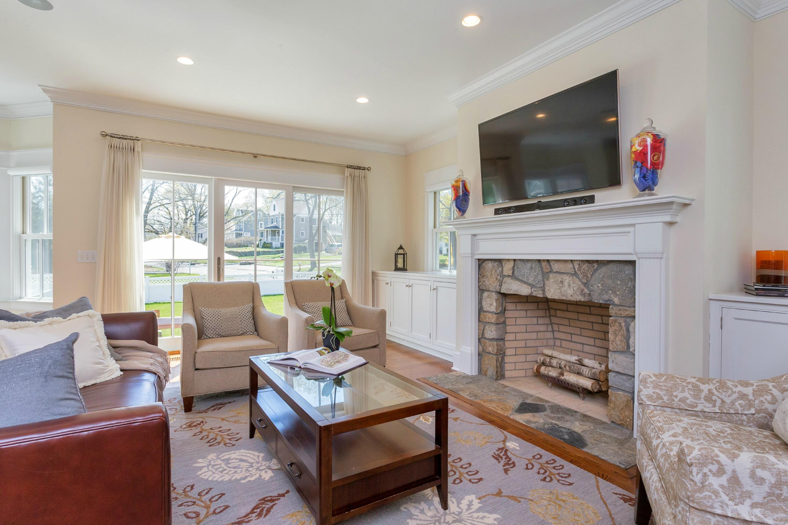 31 Edgewood Road Darien, CT 06820 - Photo 9 of 25 a living room with furniture a flat screen tv and a fireplace