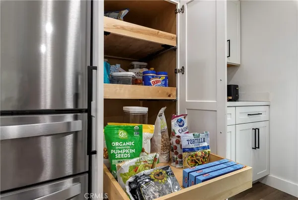a bathroom with a granite countertop toilet a sink and a mirror
