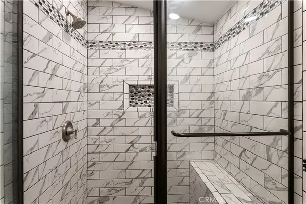 a backyard of a house with a large tree and wooden fence