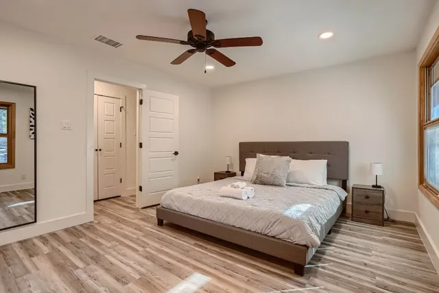 a bedroom with a bed and a ceiling fan