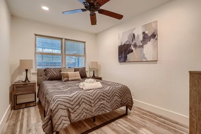 a bedroom with a bed and a painting on the wall
