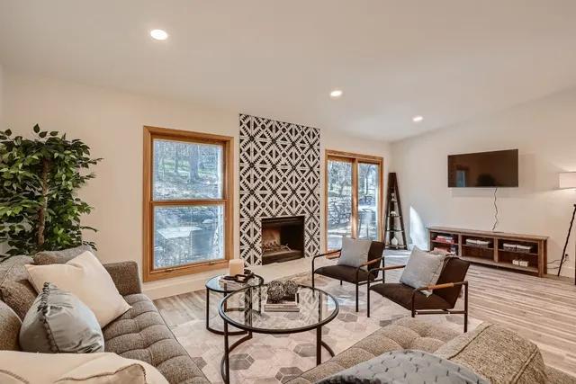 a living room with furniture and a fireplace